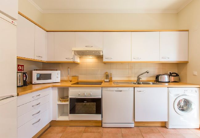 Spacious and fully equipped kitchen with dining area.