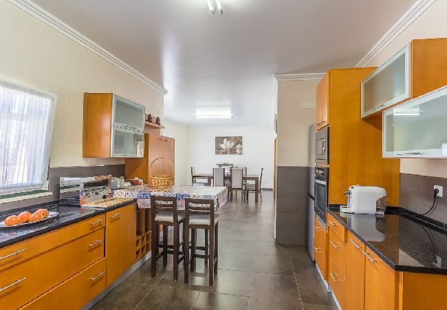 Spacious and fully equipped kitchen with dining area.