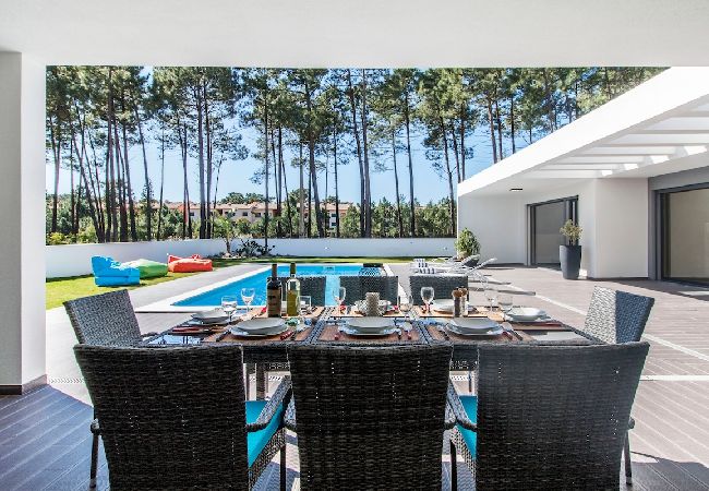 Outdoor dining area overlooking the garden and pool.