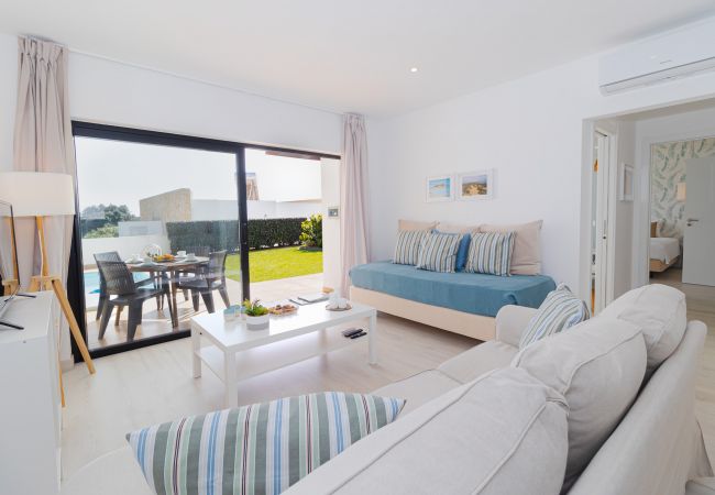 Relax in our bright and airy living room at Villa Alcione in Sagres. With plenty of natural light and cozy decor, it's the perfect space for relaxatio